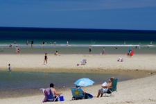 Cape Cod attractions like this photo of the Head of the Meadow sandbar at low tide with sunbathers, swimmers and beach umbrellas are what bring visitors back to Cape Cod each year 