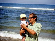 photo of a father holding a toddler near the ocean on Cape Cod at Head of the Meadow Beach