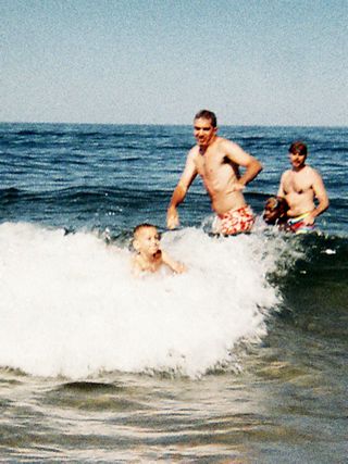 Photo of a boy riding the waves on a boogie board at Head of the Meadow Beach Cape Cod