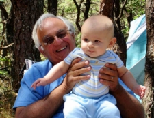 photo of grandfather holding baby in his campsite in North of Highland campgrounds on Cape Cod