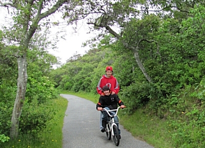 photo of two boys riding a bicycle on Head of the Meadow Cape Cod Bike Trail